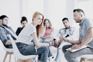 a group of people are involved in a group therapy session during their opiate addiction treatment programs