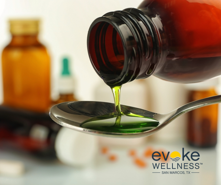 image of cough syrup being poured into spoon to highlight the dangers of dextromethorphan, or DXM.