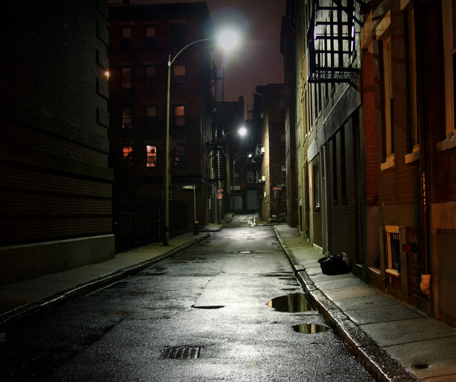 image of a dark and dimly-lit rain-slicked street in a city as a metaphor to explain what is flakka and how it is taking over urban areas